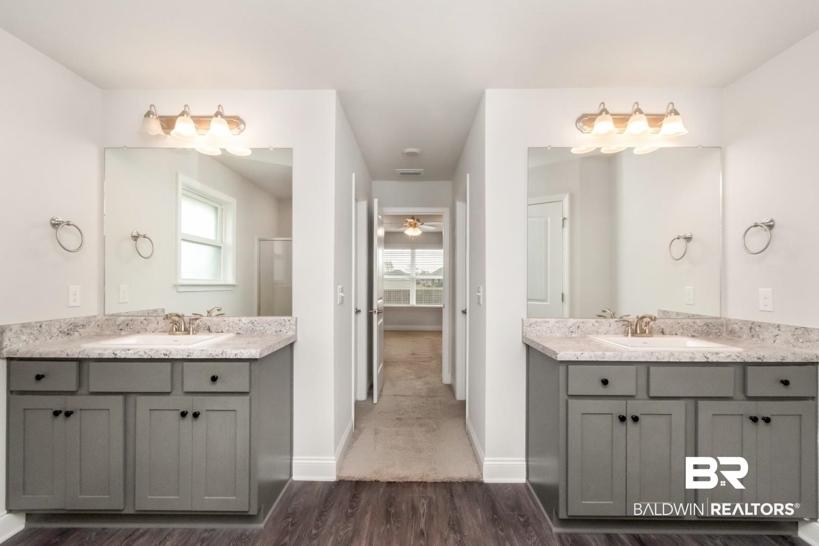 6632 Monarch Circle Mobile, AL 36618 - Photo 20 of 32 Full bath with two vanities, dark wood-style floors, and healthy amount of natural light