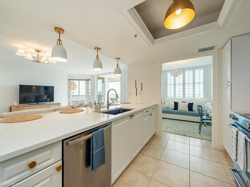 6573 Marissa Loop, Unit 802 Naples, FL 34108 - Photo 5 of 12 a kitchen with a sink and living room