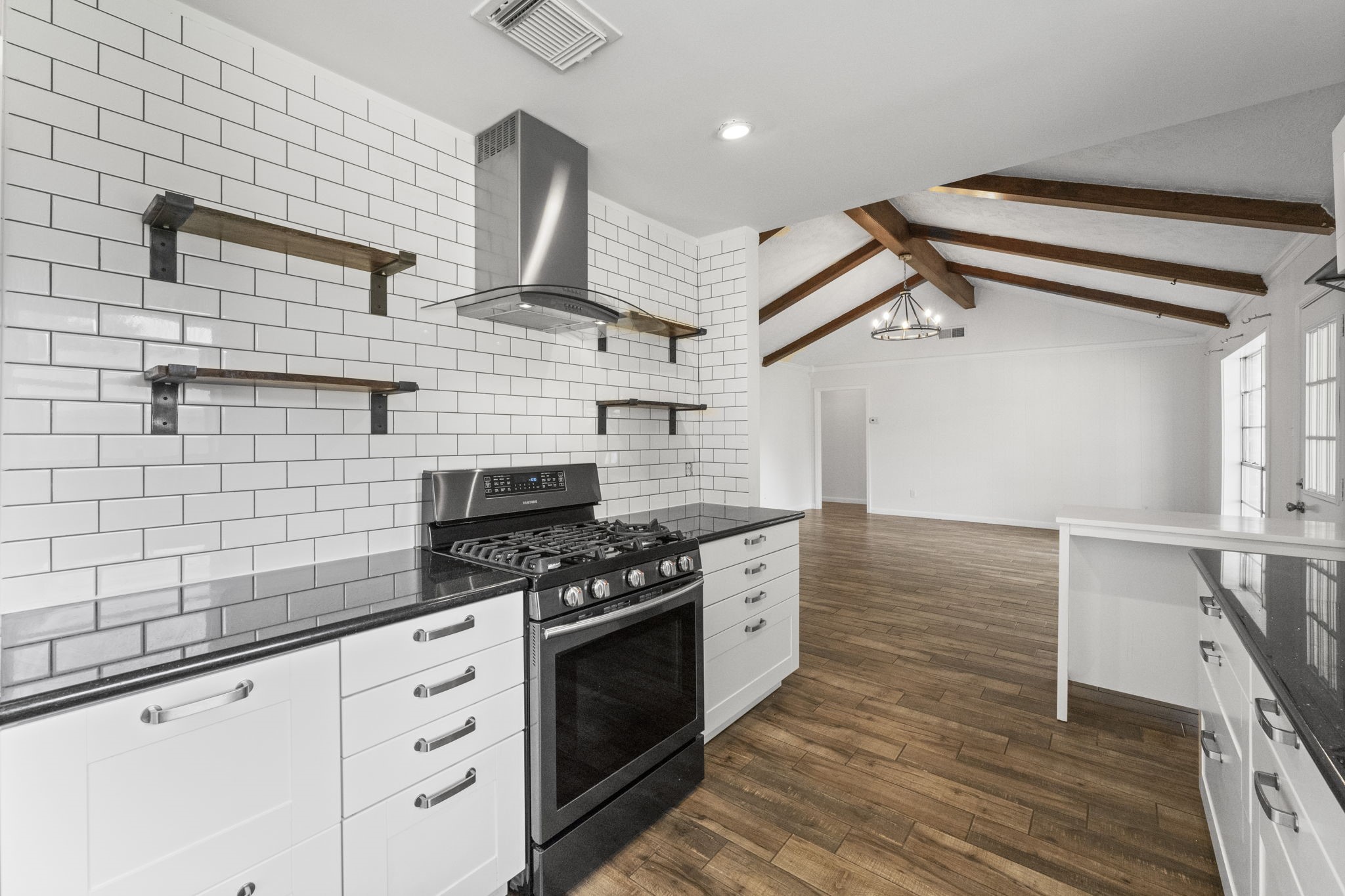9735 Kemp Forest Drive Houston, TX 77080 - Photo 9 of 25 Stylish subway backsplash with floating shelves.