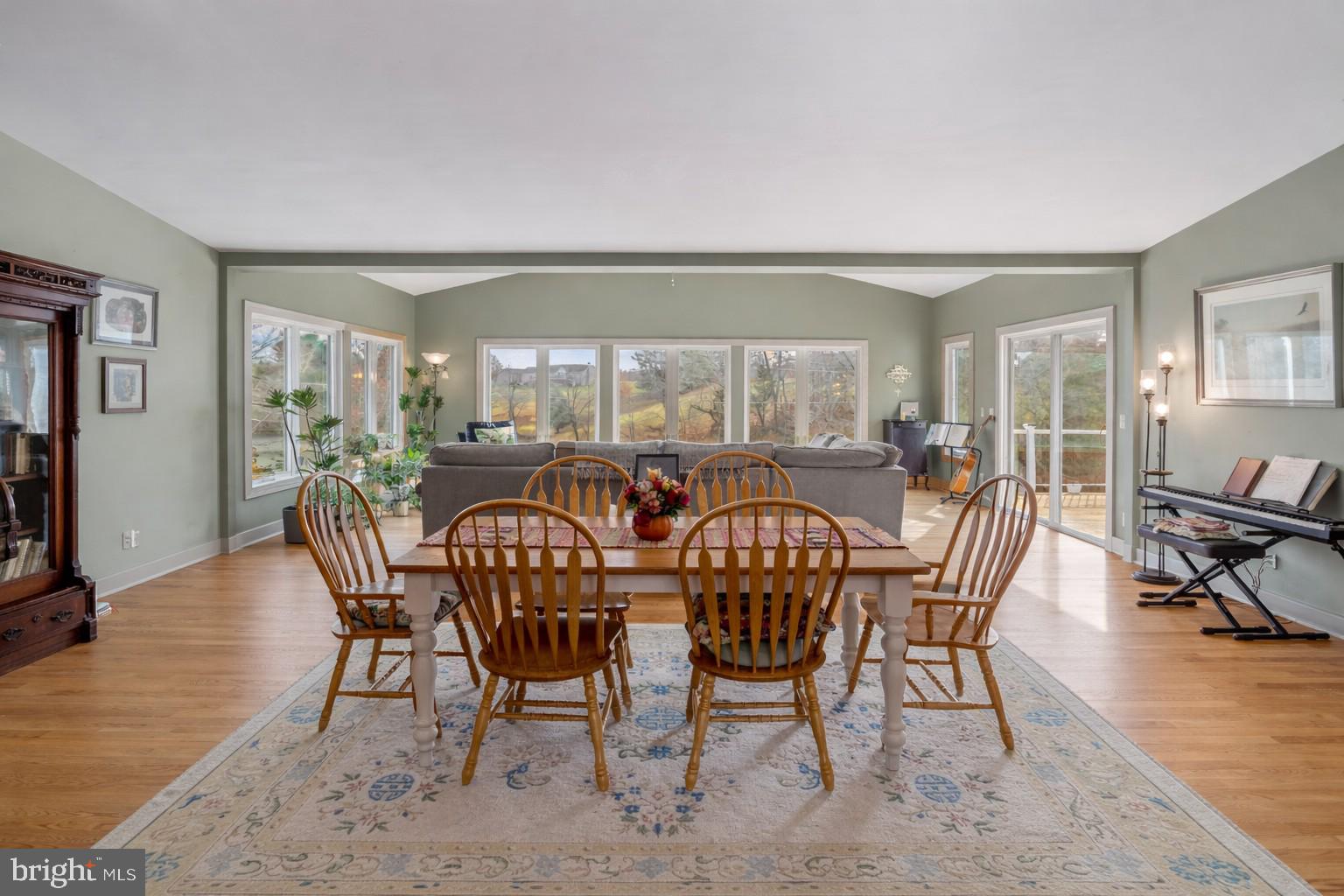 65 Chestnut Rail Lane Madison, VA 22727 - Photo 14 of 50 a view of a dining room and livingroom with furniture wooden floor a rug a painting and a chandelier