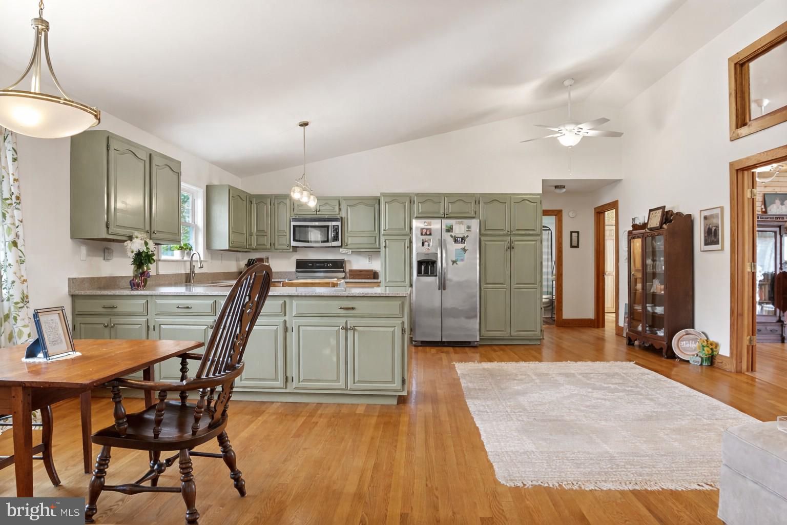 65 Chestnut Rail Lane Madison, VA 22727 - Photo 4 of 50 a kitchen with stainless steel appliances kitchen island granite countertop a table chairs sink and cabinets