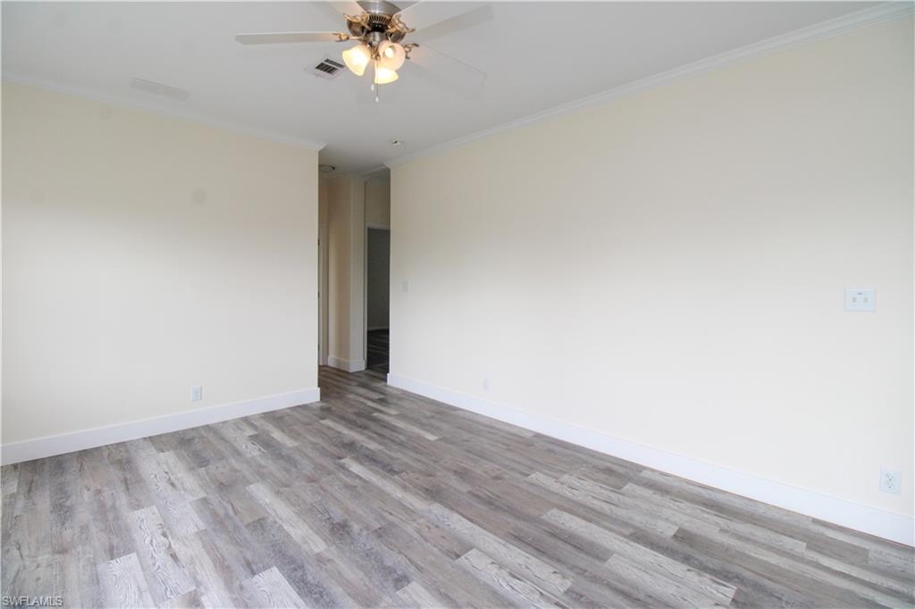 4660 43rd Avenue Northeast Naples, FL 34120 - Photo 17 of 44 a view of an empty room with wooden floor