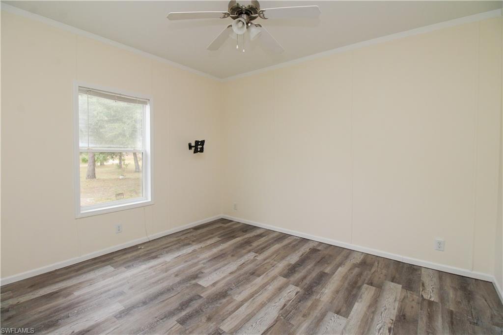 4660 43rd Avenue Northeast Naples, FL 34120 - Photo 21 of 44 an empty room with a window and a fan