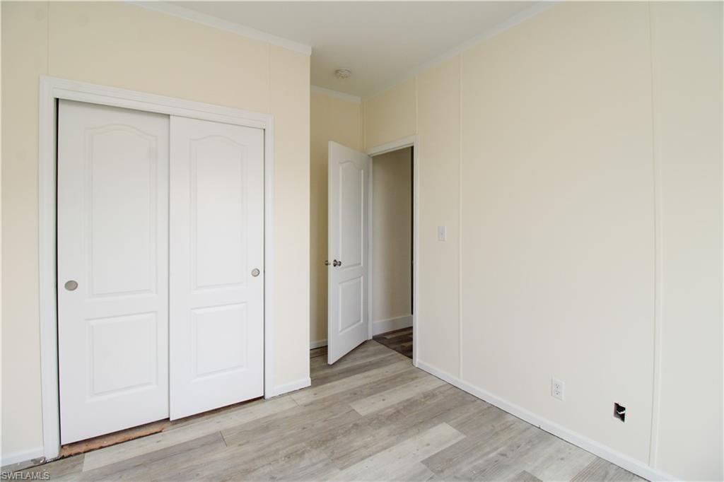 4660 43rd Avenue Northeast Naples, FL 34120 - Photo 26 of 44 an empty room with wooden floor