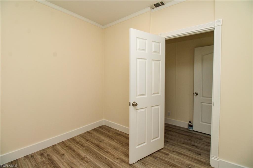 4660 43rd Avenue Northeast Naples, FL 34120 - Photo 31 of 44 a view of a hallway with wooden floor