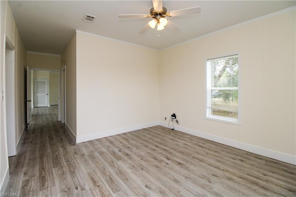 4660 43rd Avenue Northeast Naples, FL 34120 - Photo 34 of 44 a view of empty room with wooden floor and fan