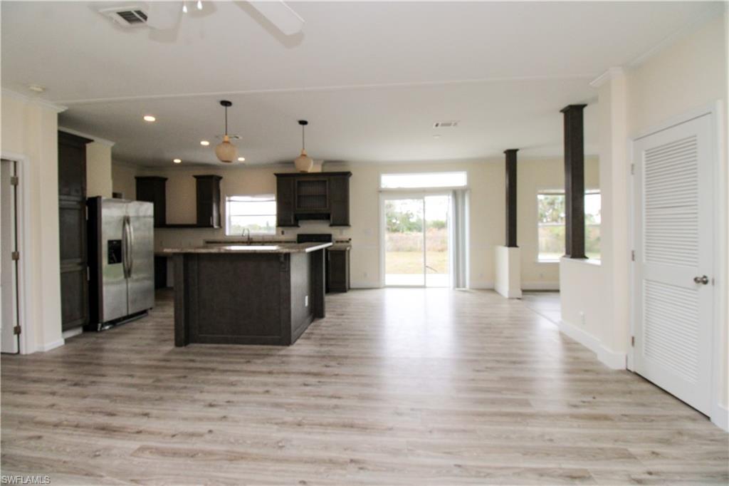 4660 43rd Avenue Northeast Naples, FL 34120 - Photo 39 of 44 a view of a kitchen with a sink and a refrigerator