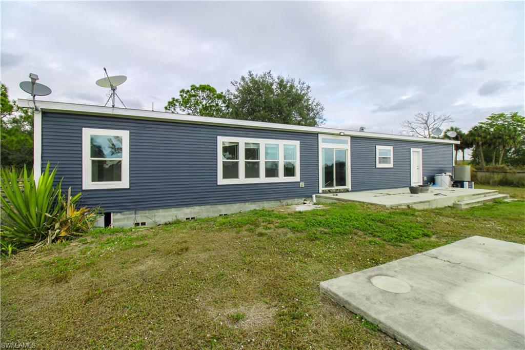 4660 43rd Avenue Northeast Naples, FL 34120 - Photo 4 of 44 a house view with a garden space