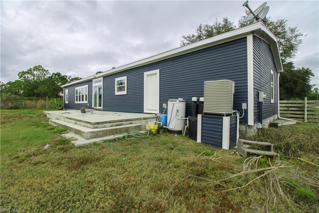 4660 43rd Avenue Northeast Naples, FL 34120 - Photo 42 of 44 a backyard of a house with table and chairs