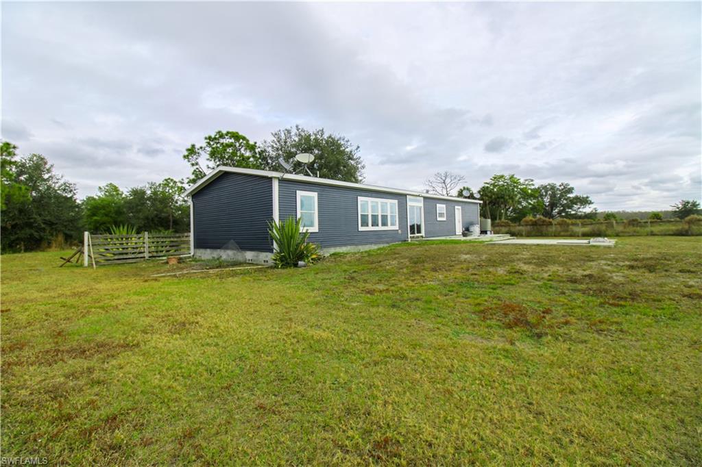 4660 43rd Avenue Northeast Naples, FL 34120 - Photo 6 of 44 a view of a house with a yard