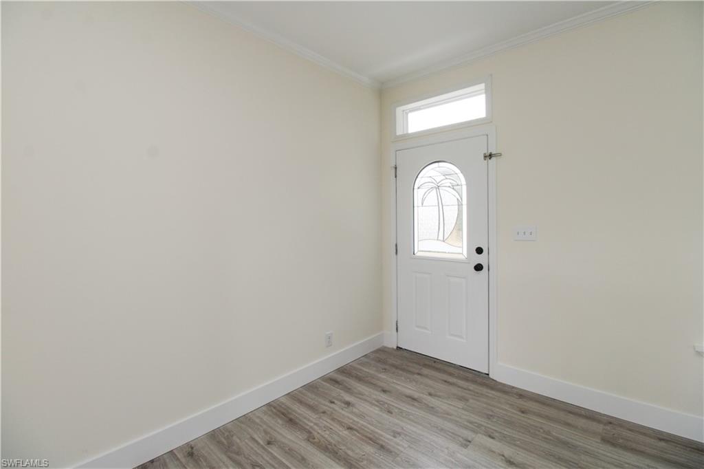4660 43rd Avenue Northeast Naples, FL 34120 - Photo 9 of 44 a view of a room with wooden floor and window