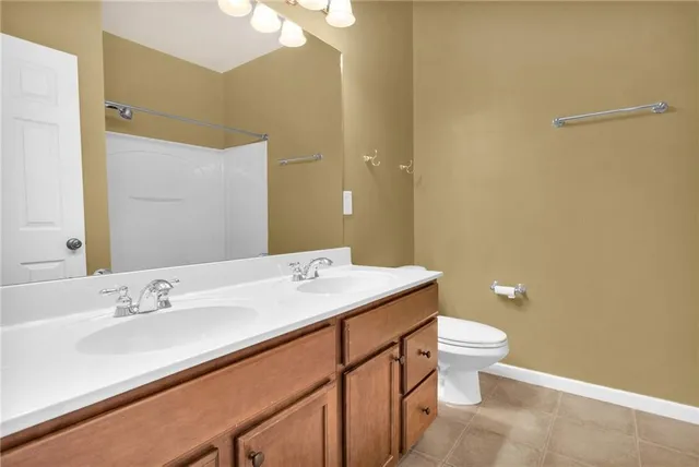 a bathroom with a sink a toilet and mirror