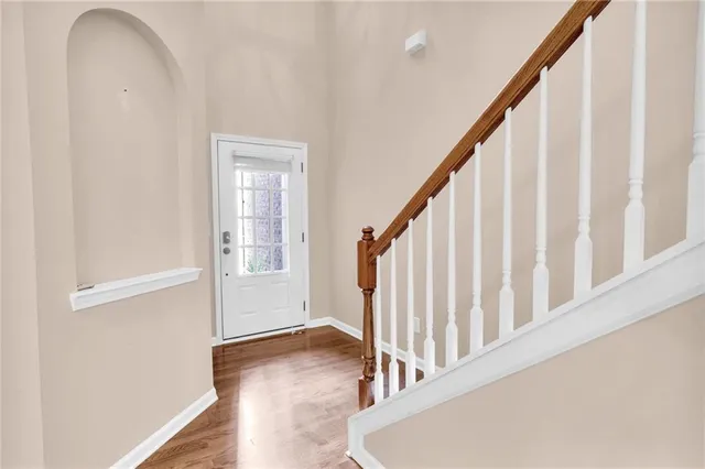 a view of staircase with railing and white walls
