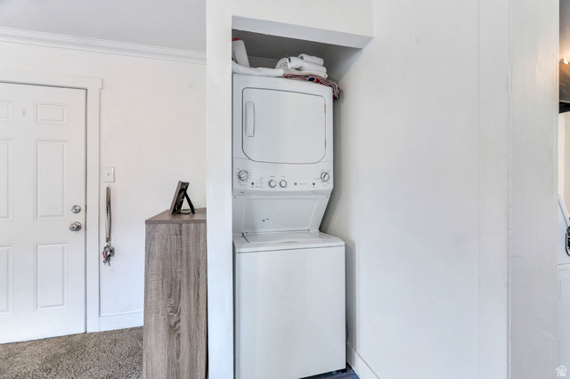 358 400 South Provo, UT 84601 - Photo 8 of 34 Laundry area with stacked washer and clothes dryer and light carpet.