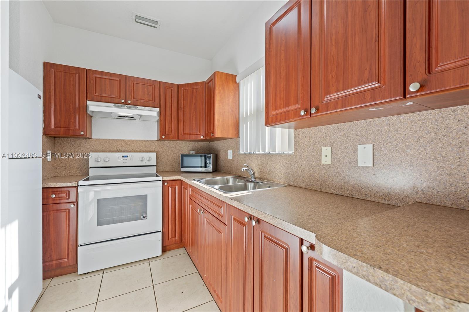 10357 Southwest 178th Street, Unit 10357 Miami, FL 33157 - Photo 13 of 25 a kitchen with stainless steel appliances granite countertop a sink stove and oven