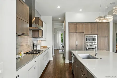 a kitchen with stainless steel appliances a sink stove and cabinets