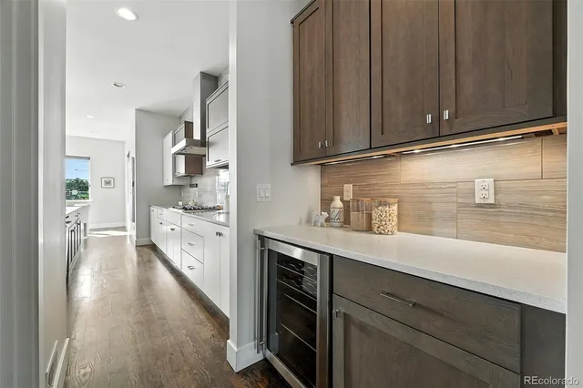 a kitchen with stainless steel appliances granite countertop a sink a stove and cabinets