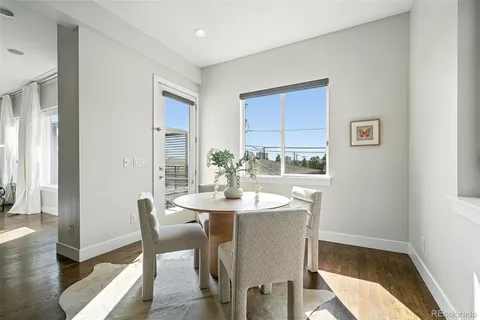a dining room with furniture and wooden floor