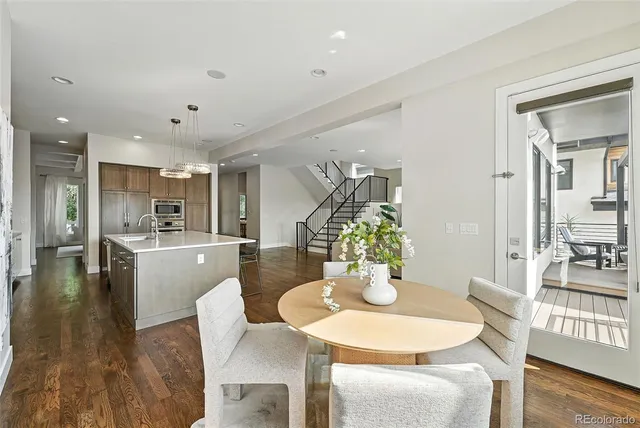a dining room with furniture and wooden floor