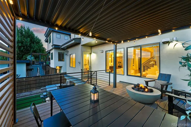 a front view of a house with outdoor seating