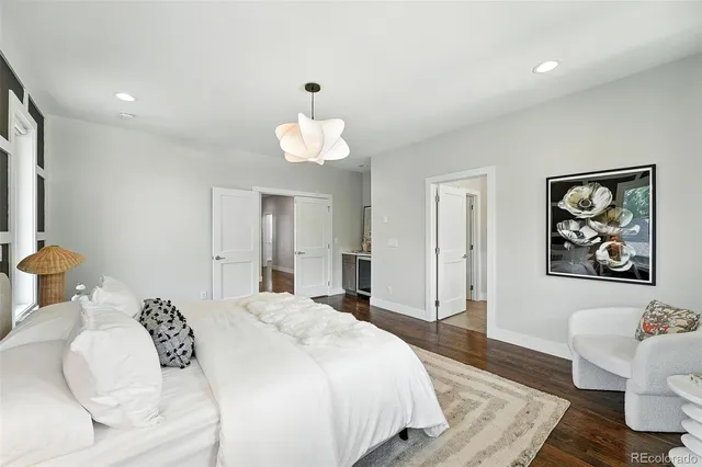 a bedroom with a bed and a chandelier