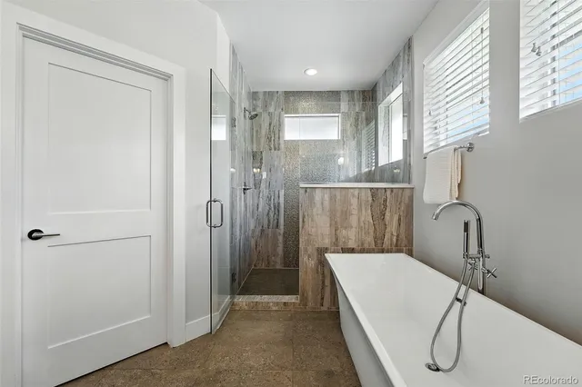 a bathroom with a granite countertop sink a mirror and a shower