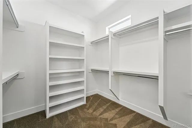 a view of walk in closet with empty racks