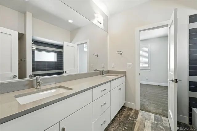 a bathroom with a sink double vanity and a mirror