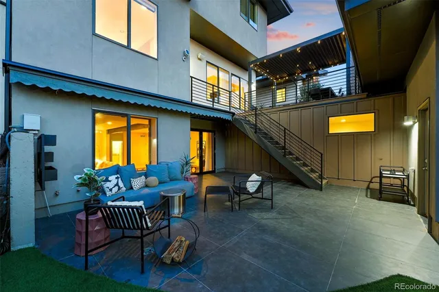a roof deck with couches and wooden floor
