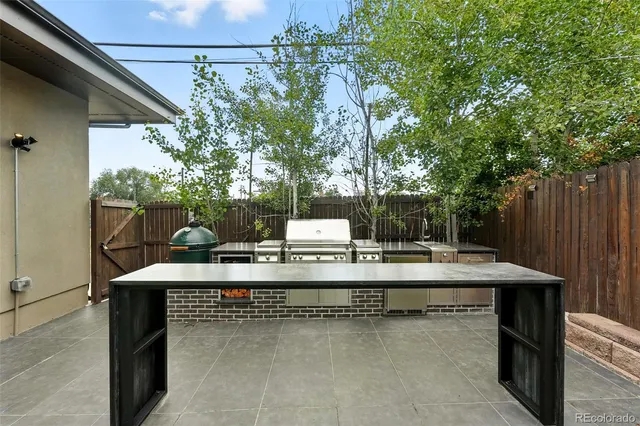 a view of a yard with a table and chairs
