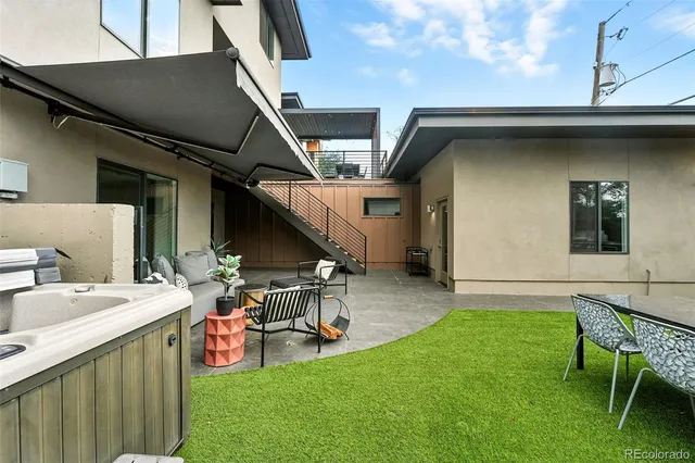 a backyard of a house with table and chairs