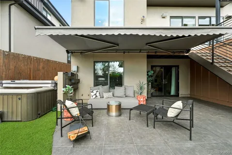 a view of a patio with table and chairs and potted plants