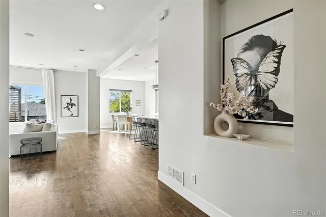 wooden floor with white walls and window