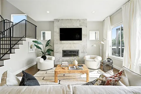 a living room with furniture fireplace and a flat screen tv