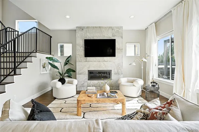 a living room with furniture fireplace and a flat screen tv
