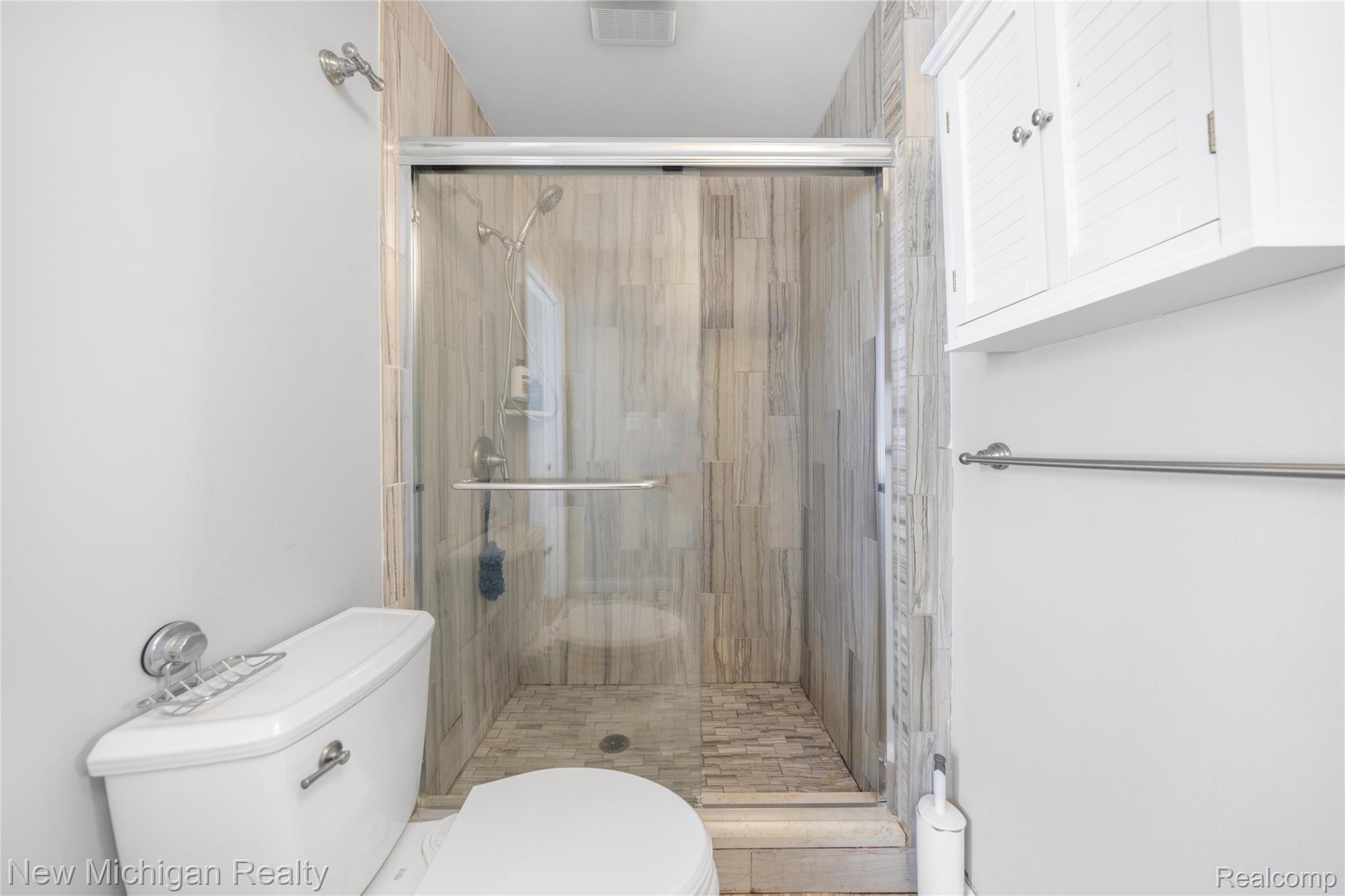 8665 Cooley Lake Road Commerce Township, MI 48382 - Photo 33 of 52 Bathroom featuring a stall shower