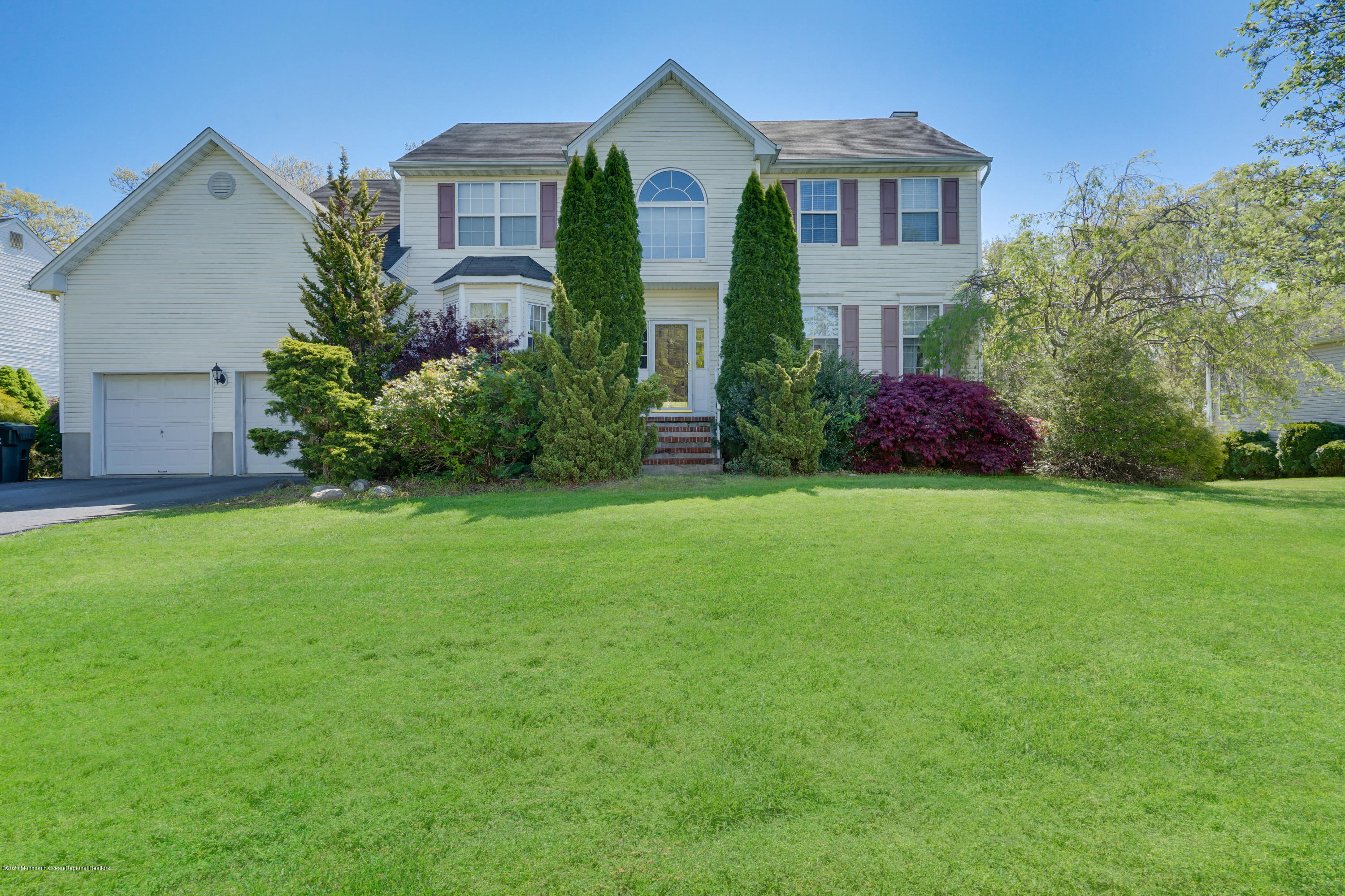 a front view of house with yard and green space