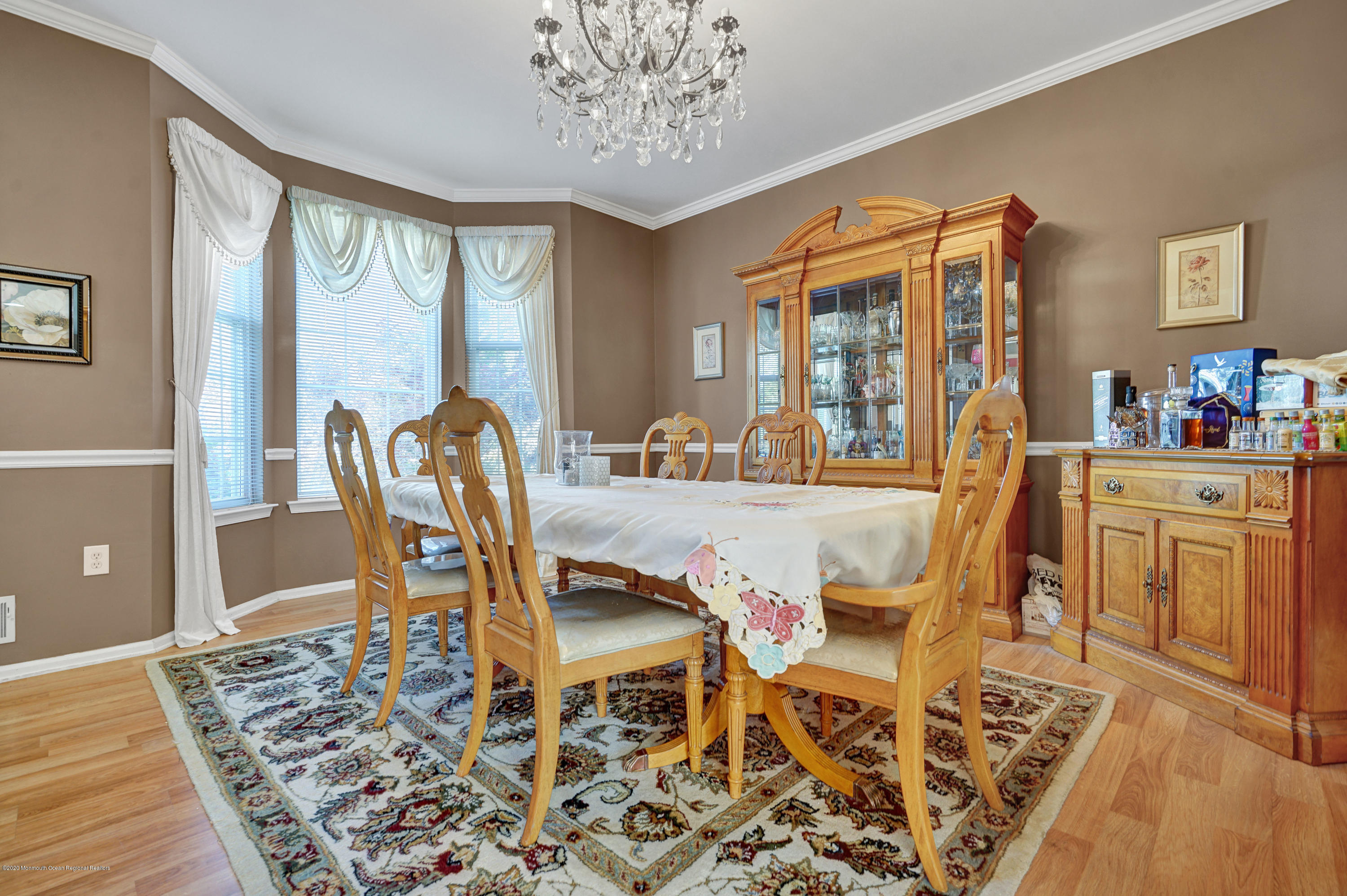 19 Cortelyou Road Jackson, NJ 08527 - Photo 20 of 56 a dining room with furniture a rug a potted plant and a chandelier