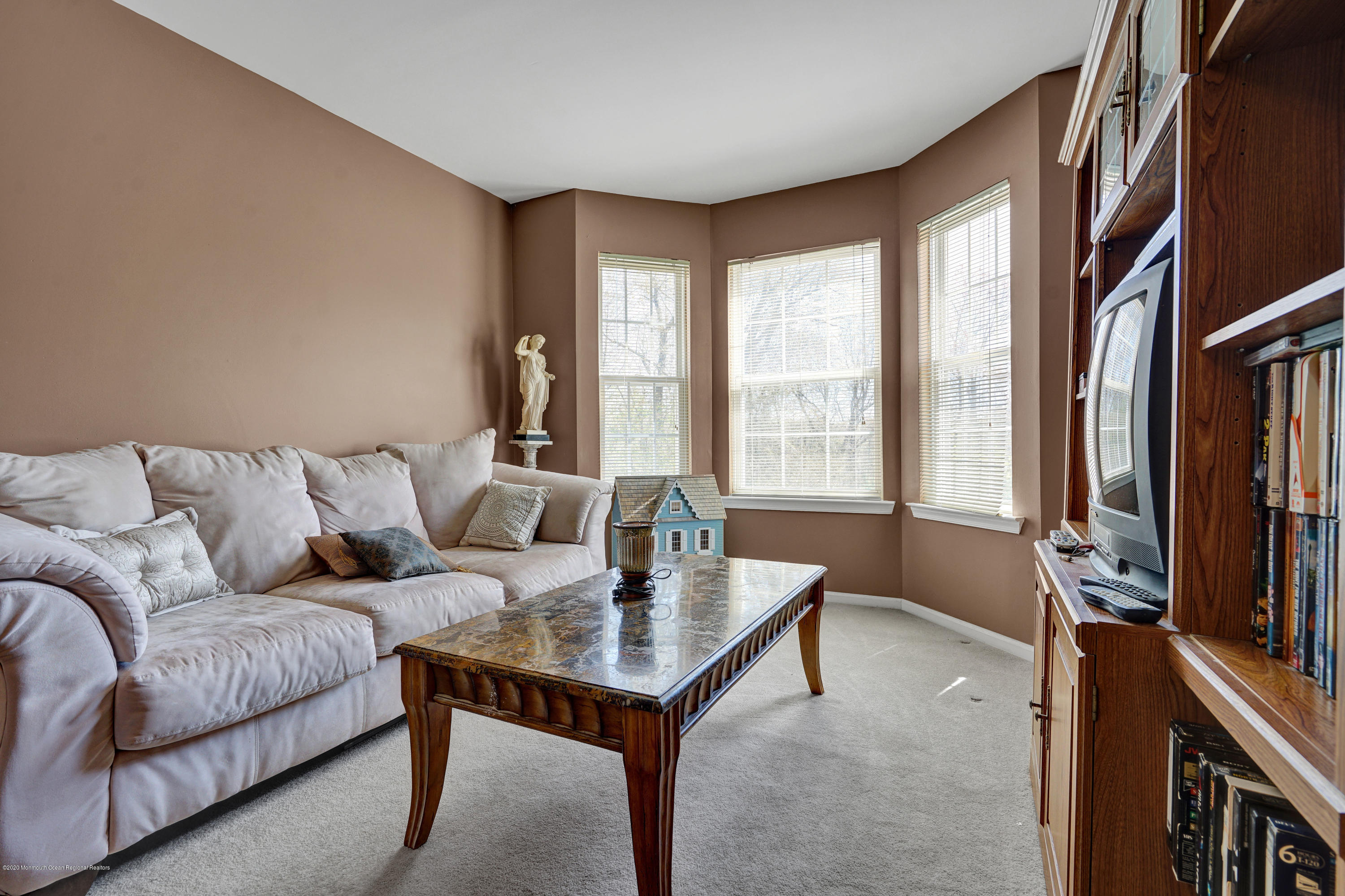 19 Cortelyou Road Jackson, NJ 08527 - Photo 29 of 56 a living room with furniture a flat screen tv and a large window