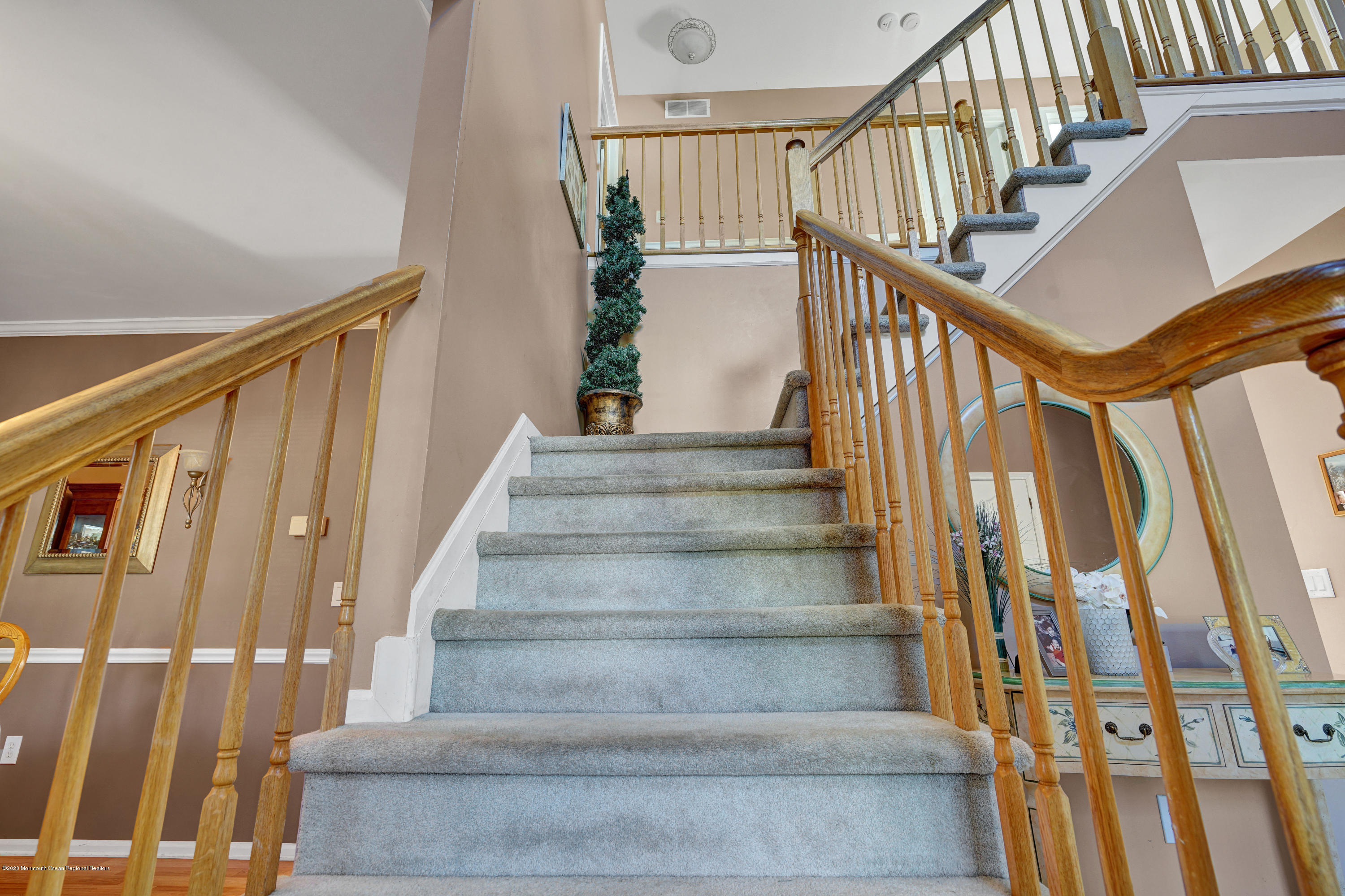 19 Cortelyou Road Jackson, NJ 08527 - Photo 42 of 56 a view of staircase with lots of frames on wall and a large window