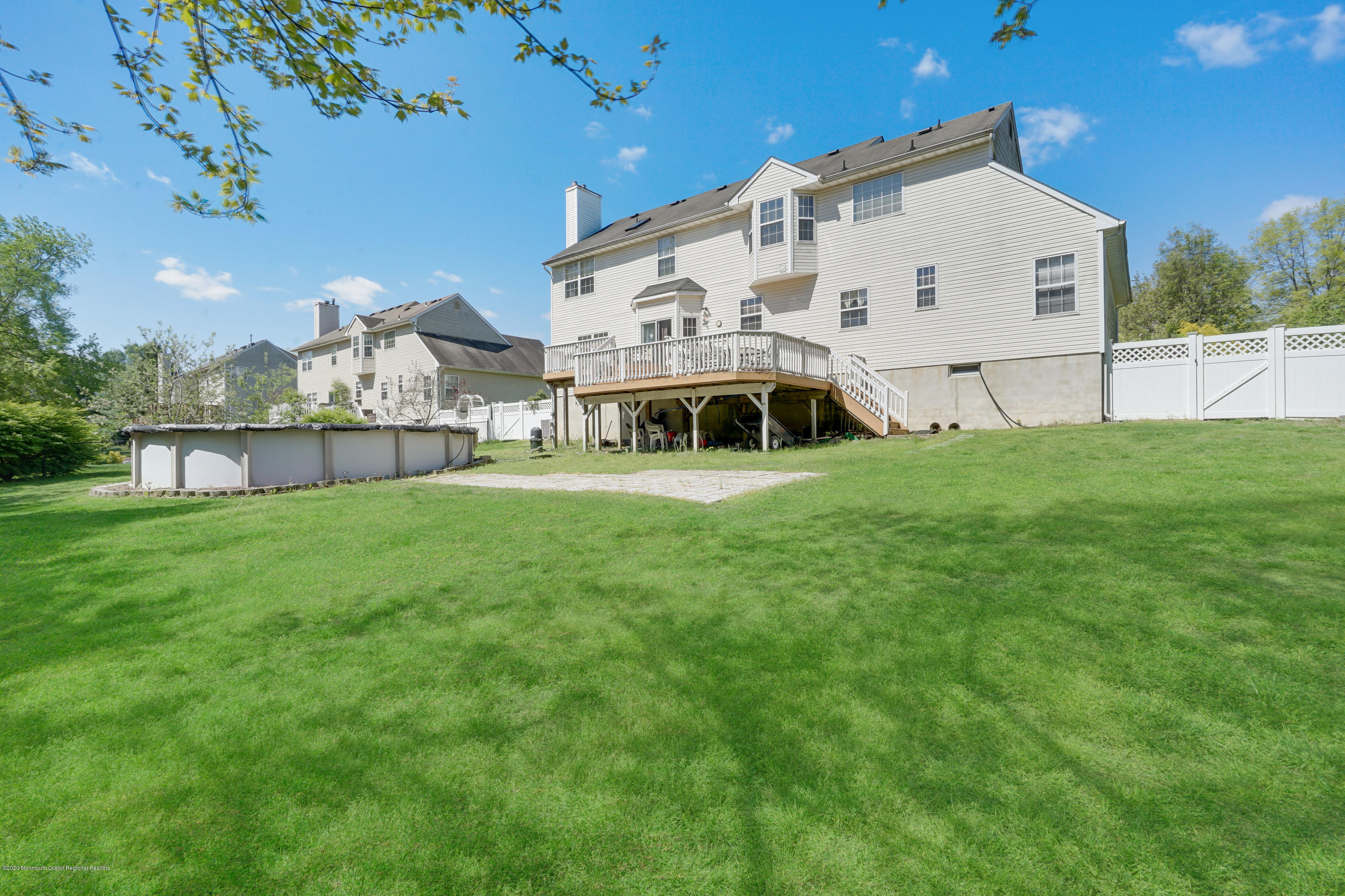 19 Cortelyou Road Jackson, NJ 08527 - Photo 49 of 56 a view of a white house with a big yard and large trees