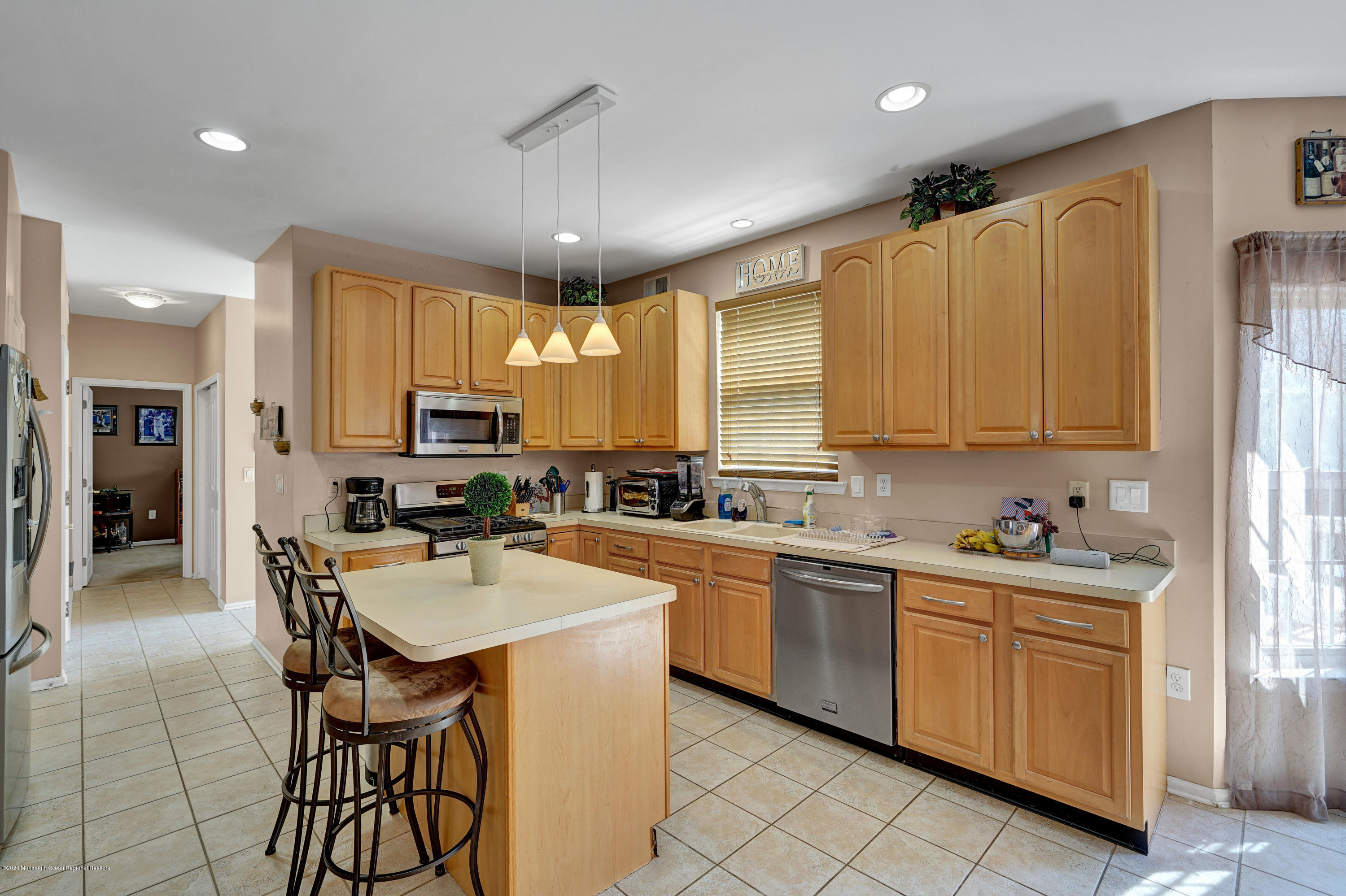 19 Cortelyou Road Jackson, NJ 08527 - Photo 10 of 56 a kitchen with stainless steel appliances a sink a stove a refrigerator cabinets and chairs