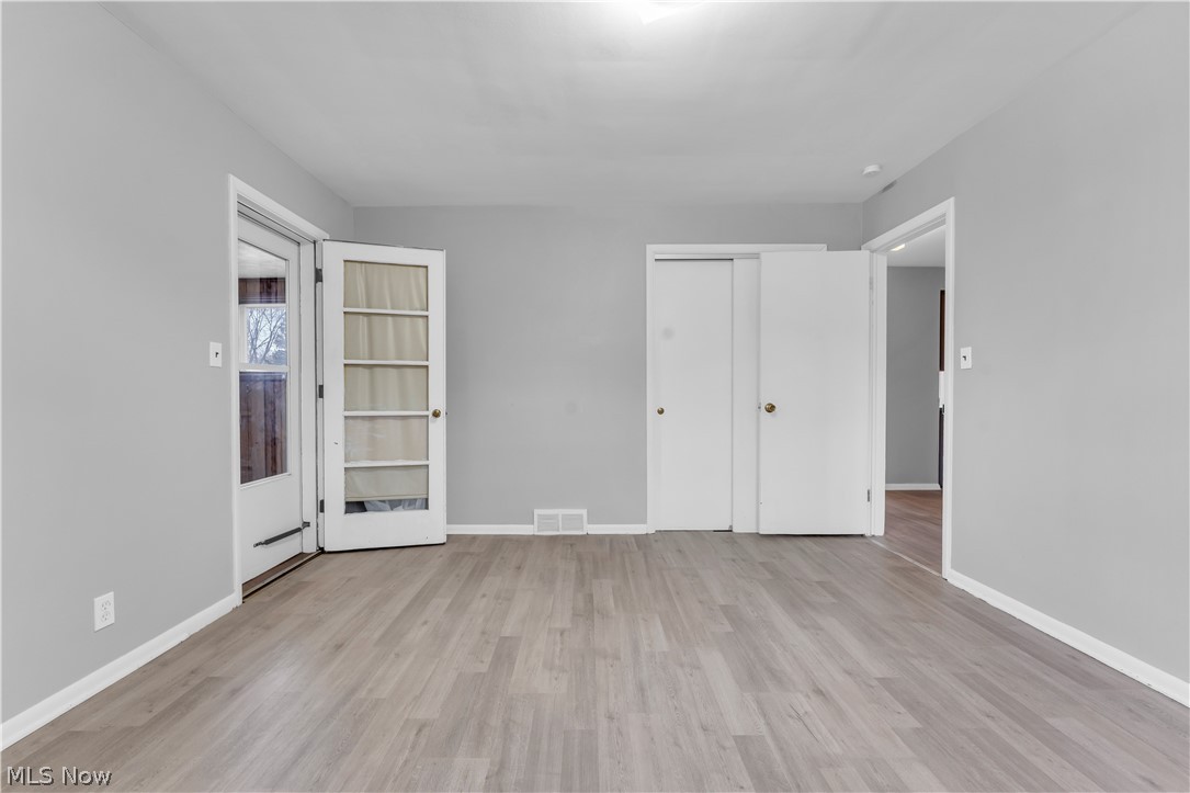 2915 Snow Road, Unit 2/UP Cleveland, OH 44134 - Photo 4 of 23 Spacious room featuring wood-finish flooring, light grey walls, and white trim