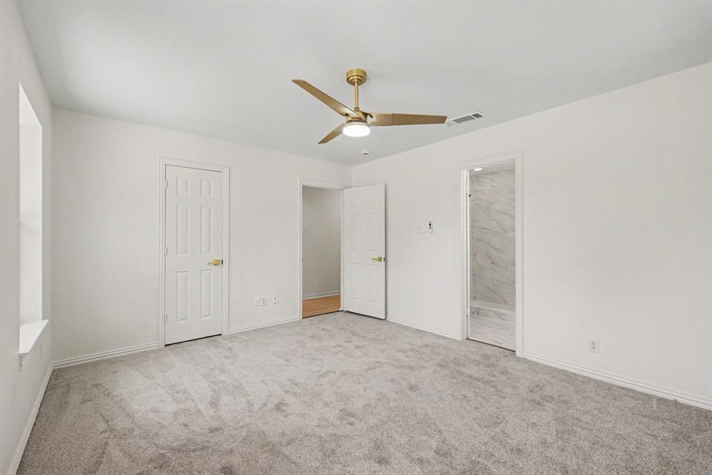 307 Dixon Street Terrell, TX 75160 - Photo 21 of 32 Spacious room with plush gray carpeting, white walls, and a contemporary brass ceiling fan with integrated lighting