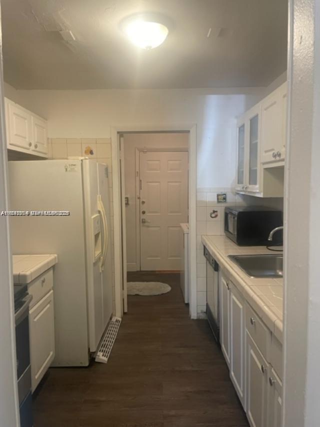 2993 Northwest 191st Terrace Miami Gardens, FL 33056 - Photo 2 of 9 a kitchen with stainless steel appliances a refrigerator and a stove