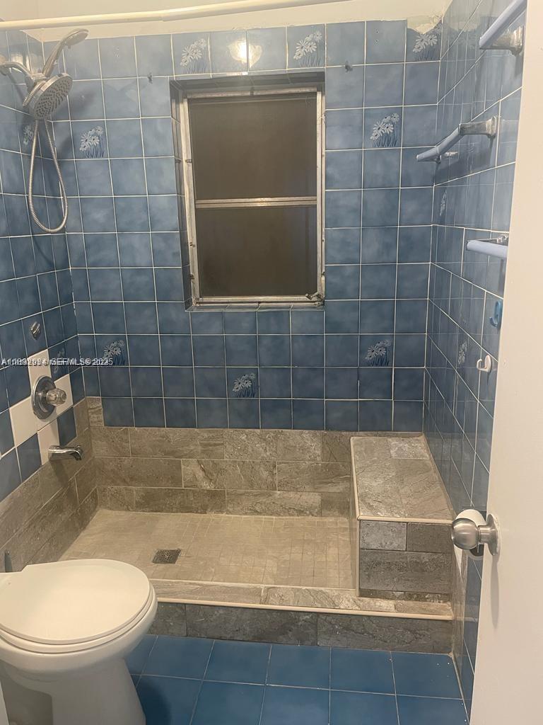 2993 Northwest 191st Terrace Miami Gardens, FL 33056 - Photo 7 of 9 a bathroom with a shower and a toilet