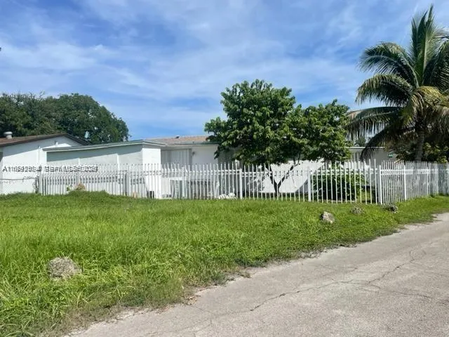 a view of a garden with a building in the background