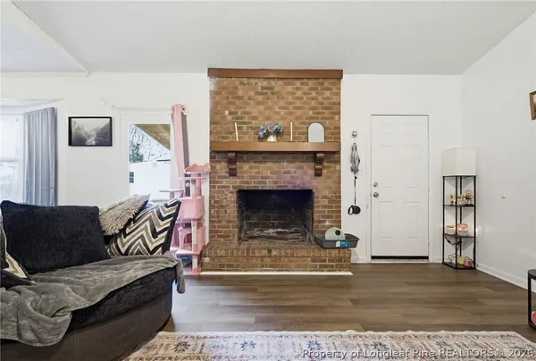a living room with furniture and a bookshelf