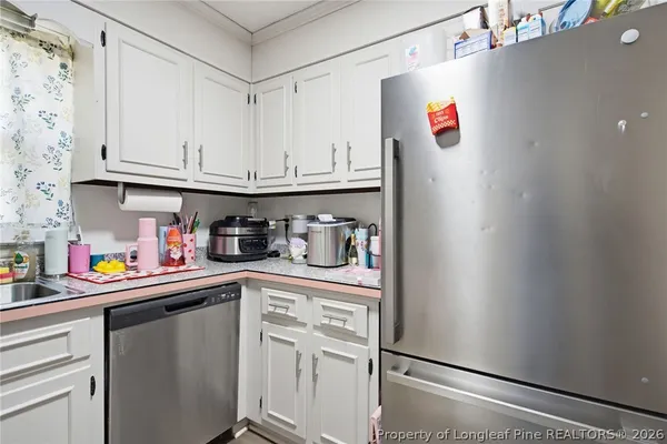 a front view of a house with a yard and potted plants