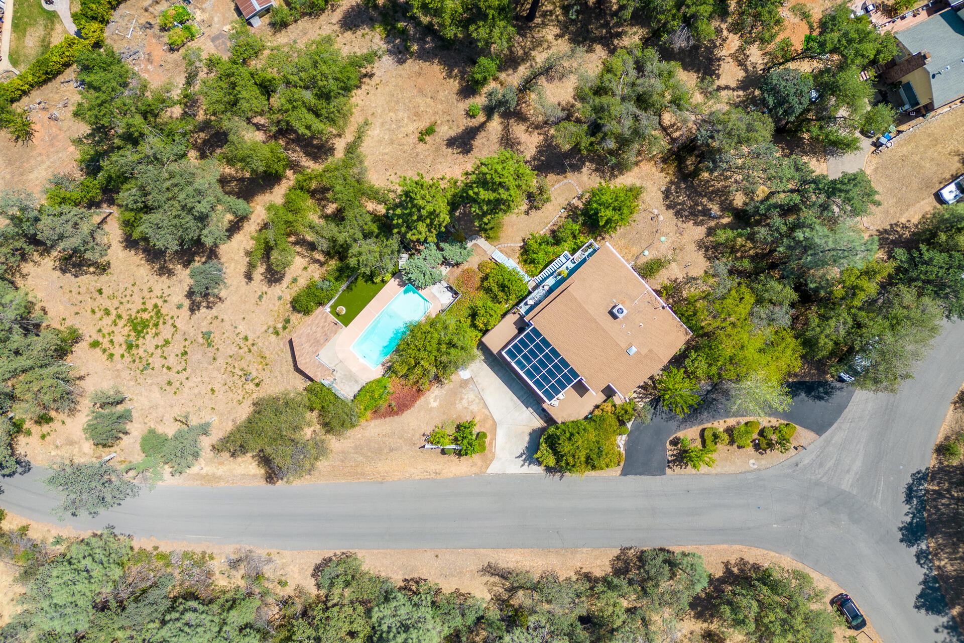 8695 Valley View Road Redding, CA 96001 - Photo 54 of 62 an aerial view of a house with a yard and large trees